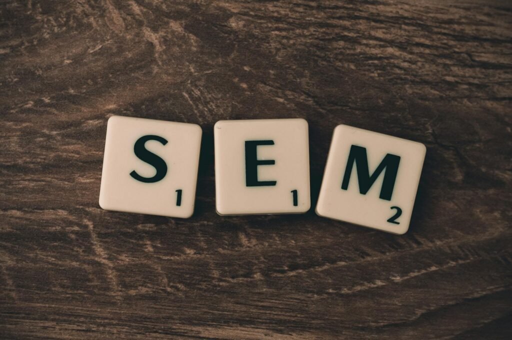 Wooden background with letter tiles spelling SEM, representing search engine marketing.